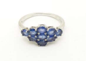 A 9ct white gold ring set with blue stones. Ring size approx. N Please Note - we do not make