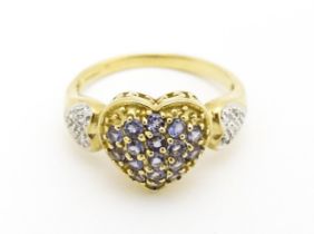 A 9ct gold ring set with lilac coloured iolite and diamonds. Ring size approx. N Please Note - we do