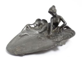 A WMF Art Nouveau figural pewter dish modelled as a maiden beside a pond with lily pads. Marked