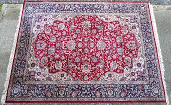 Carpet / Rug : A red ground rug decorated with floral and foliate detail with stylised animals, with