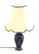 A table lamp with vase formed base with blue ground and gilt detail. Approx. 22" high overall Please