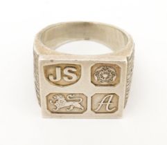 A silver signet ring with hallmark decoration to top. Hallmarked Sheffield 1975 maker Jack