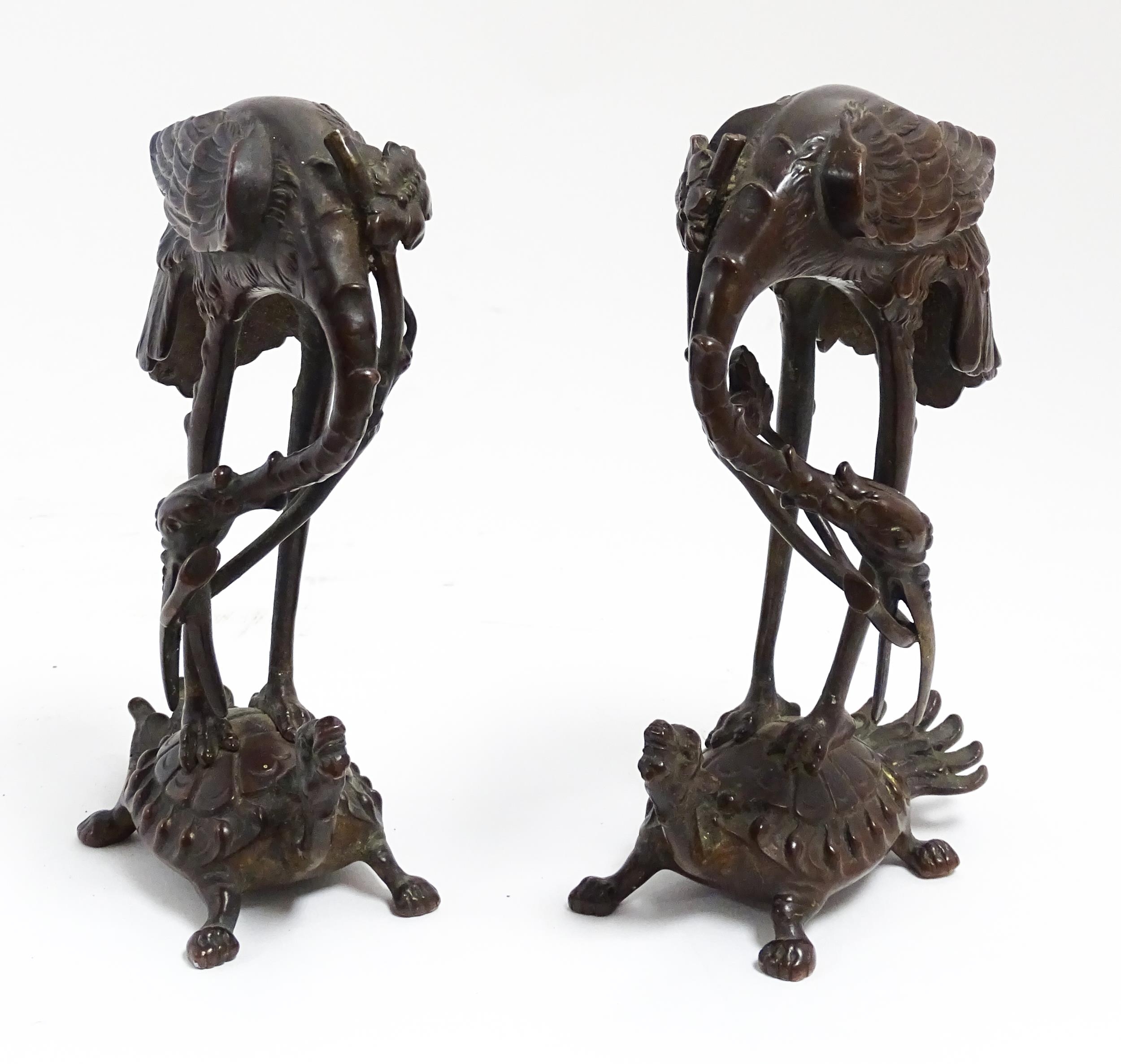 A pair of Japanese cast sculptures modelled as a stylised crane standing on a tortoise. Approx. 7 - Image 3 of 6