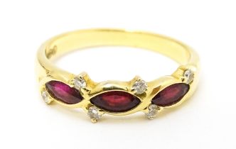 An 18ct gold ring set with three rubies and six diamonds. Ring size approx. P 1/2 Please Note - we