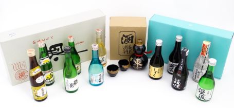 A boxed ceramic Saki decanter with two cups, together with a Keiryu Monde Selection Gold Award