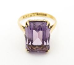 A 9ct gold dress ring set with central amethyst. Ring size approx. J 1/2 Please Note - we do not