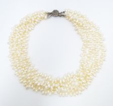 A four strand pearl necklace / choker. Approx 15" long Please Note - we do not make reference to the