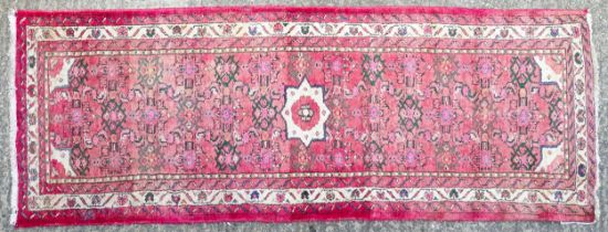 Carpet / Rug : A runner with pink red grounds decorated with floral foliate and geometric motifs