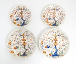 Four Derby plates / dishes decorated in the Formal Lotus Tree pattern in a Japanese Kakiemon