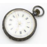 A Continental .935 silver cased fob watch with engraved decoration and white enamel dial with