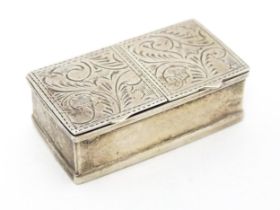 A silver two sectional pill box with engraved acanthus scroll decoration, bearing import marks.
