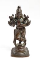 A small Indian bronze model of the deity Vishnu holding a chakra and sankha. Approx. 3" high