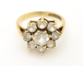 A 9ct gold ring set with white stones. Ring size approx N. Please Note - we do not make reference to