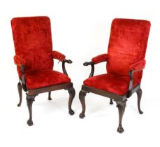 A pair of Irish 19thC mahogany armchairs with carved dog masks to the arms, upholstered
