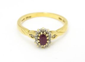 An 18ct gold ring set with central ruby bordered by diamonds. Ring size approx. M 1/2. Please Note -