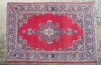 Carpet / Rug : A Central Persian Kashan Rug the red ground with central vignette having floral and