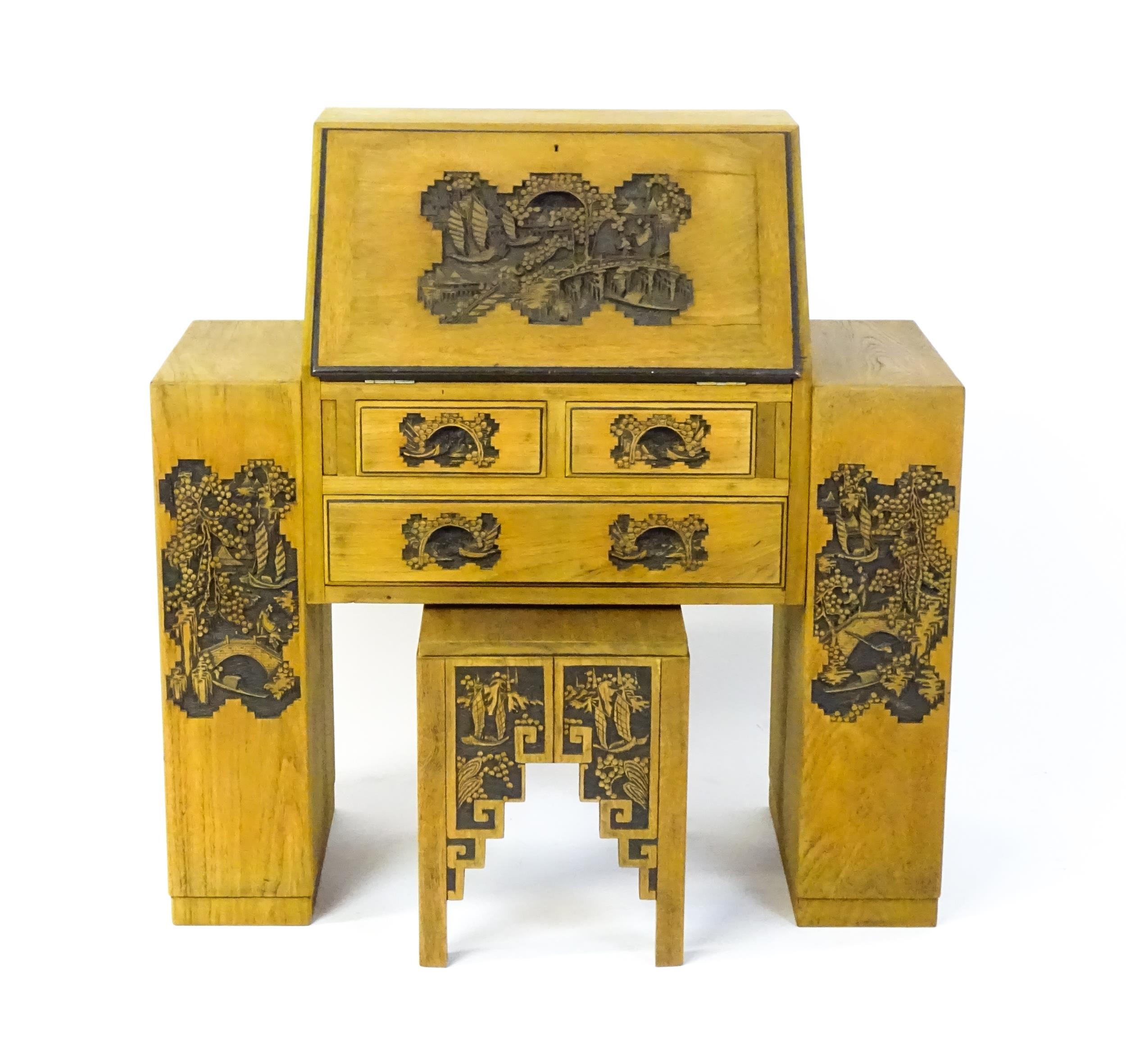 An early / mid 20thC Teak bureau accompanied by a stool, with carved oriental scenes to the front, - Image 9 of 12