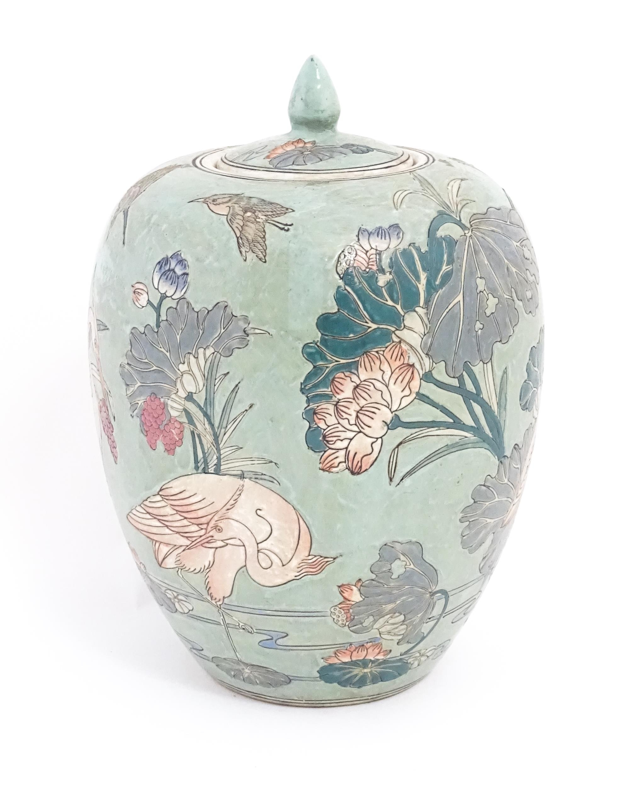 A Chinese ginger jar with celadon style glaze decorated with crane birds, flowers, lily pads, etc. - Image 3 of 8