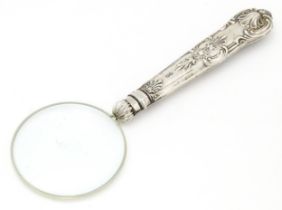 A magnifying glass with silver handle. Approx. 6" long Please Note - we do not make reference to the