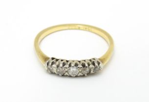 An 18ct gold ring with five diamonds in a linear setting. Ring size approx. O 1/2 Please Note - we