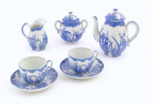 A quantity of Oriental blue and white tea wares decorated with iris flowers and foliage, to