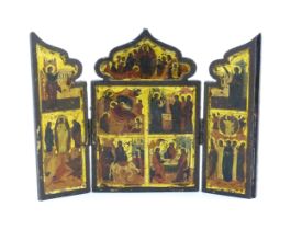 A 19thC Russian Orthodox carved wooden triptych icon with eight tempera depictions of events in