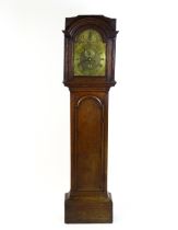 An 8-day oak longcase clock with brass face approx 11 1/2" wide signed ' Geo e Parker Wisbich ' (