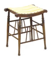 An early 20thC Aesthetic style stool in the Liberty style, with a concave top above four turned