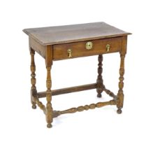 An 18thC oak side table with a moulded top above a single long frieze drawer, the table raised on