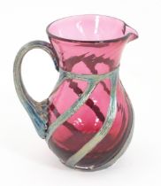 A cranberry glass jug with silver overlay detail by Sileda Ltd. Approx. 3 3/4" high Please Note - we