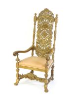 A 20thC Carolean style armchair, with a carved and pierced backrest, floral decoration, turned