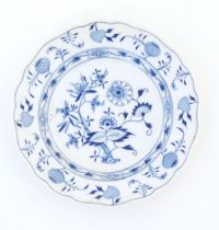 A Meissen style blue and white plate decorated in the Onion pattern. Crossed sword mark under.