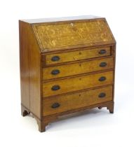 An 18thC oak bureau with a crossbanded fall front containing a fitted interior with small drawers,