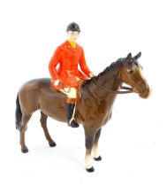 A Beswick Huntsman on a brown horse, model no. 1501. Marked under. Approx. 8" high Please Note -