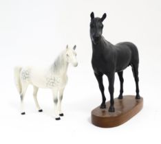 Two Royal Doulton models of horses comprising Black Beauty and a dapple grey horse. Largest