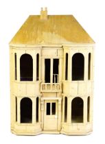 A 20thC scratch built pine dolls house with pitched roof and bay windows, the front opening to