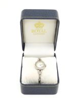 A ladies white metal wristwatch, the dial signed international and surrounded by 21 diamonds,