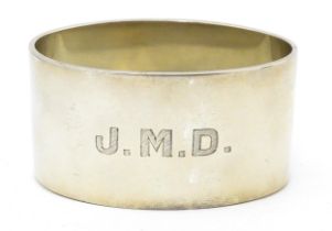 A silver napkin ring of oval form, hallmarked Birmingham 1942, maker J B Chatterley & Sons Ltd.