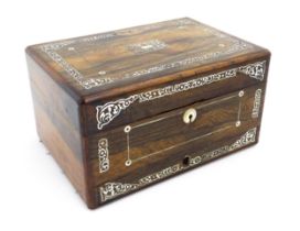 A Victorian rosewood workbox with drawer under, the exterior decorated with mother of pearl inlay.