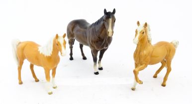 Three Beswick models of horses comprising a palomino Prancing Arab model no. 1261, a palomino Arab