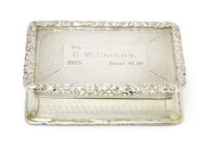 A silver snuff box with waisted sides and engine turned decoration, opening to reveal a gilded