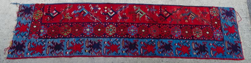 Carpet / Rug : A section of rug with blue and red banded grounds decorated with floral motifs and