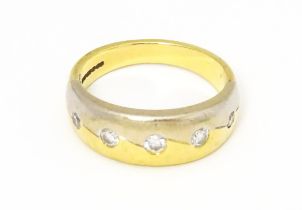 An 18ct white and yellow gold ring set with five diamonds. Ring size approx L Please Note - we do