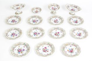 A German part dessert service with pierced borders and floral decoration, to include plates, basket,