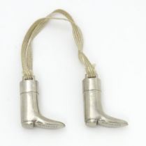 An unusual pair of early 20thC novelty silver plate knitting needle guards formed as riding boots.