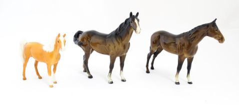 Three Beswick models of horses comprising a brown horse with swish tail, no. 1182, a brown imperial,