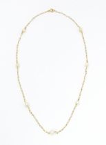 A 9ct gold necklace set with pearls. Approx. 17" long Please Note - we do not make reference to