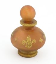 A glass scent / perfume bottle by Jenny Blair with gilt fleur de lys. Approx. 2 3/4" high Please