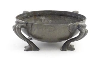 A Liberty & Co. Tudric pewter bowl of circular form raised on four Art Nouveau scrolled supports,