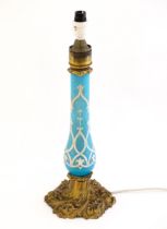 A 20thC gilt brass table lamp with acanthus and floral detail, the turquoise column with tracery